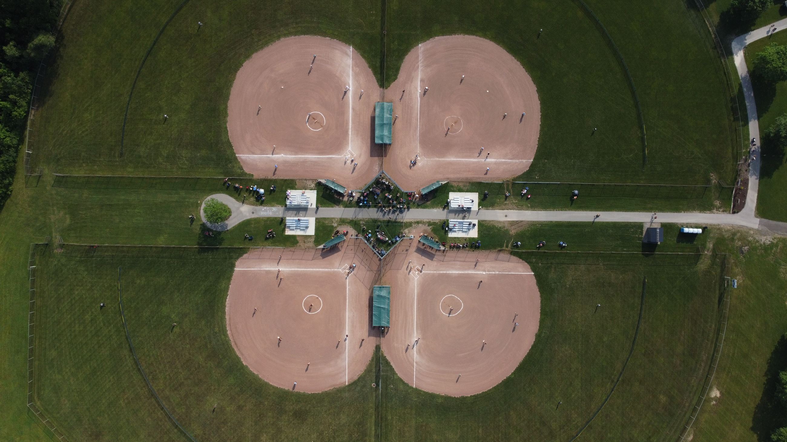 birds-eye-view of four baseball/softball fields with players on it (fields 7-10)